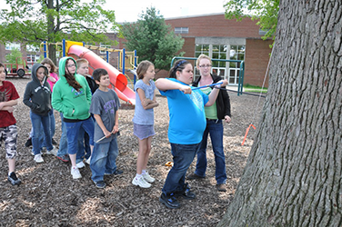 Sarah Appleton '11 helps Cornerstone students core a tree